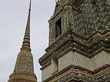 Bangkok 03 04 Wat Po Chedi Next to the Reclining Buddha wiharn is an enclosure holding the four largest of the temple's 95 chedis, each 42m high. All of the chedi at Wat Po are square, rather than the round bell shape generally preferred at the time. They are decorated with ceramic tiles and three dimensional ceramic pieces which form intricate floral patterns. The centre of the three chedi in a line is the oldest, having been built by Rama I to hold the Phra Si Sanphet Buddha image bought from Ayuthaya. Later, Rama III built the chedi north of this to hold the ashes of Rama II, and the one to the south to hold his own remains. The fourth chedi was built by Rama IV for unknown purposes.